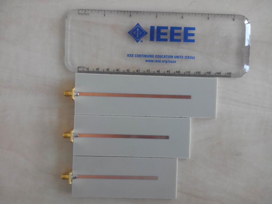 Verification by measurement Figure 7.11 Bottom layers of the manufactured test cases of the three-element filtennas: upper filtenna at the frequency 4.8 GHz; middle filtenna at 5.