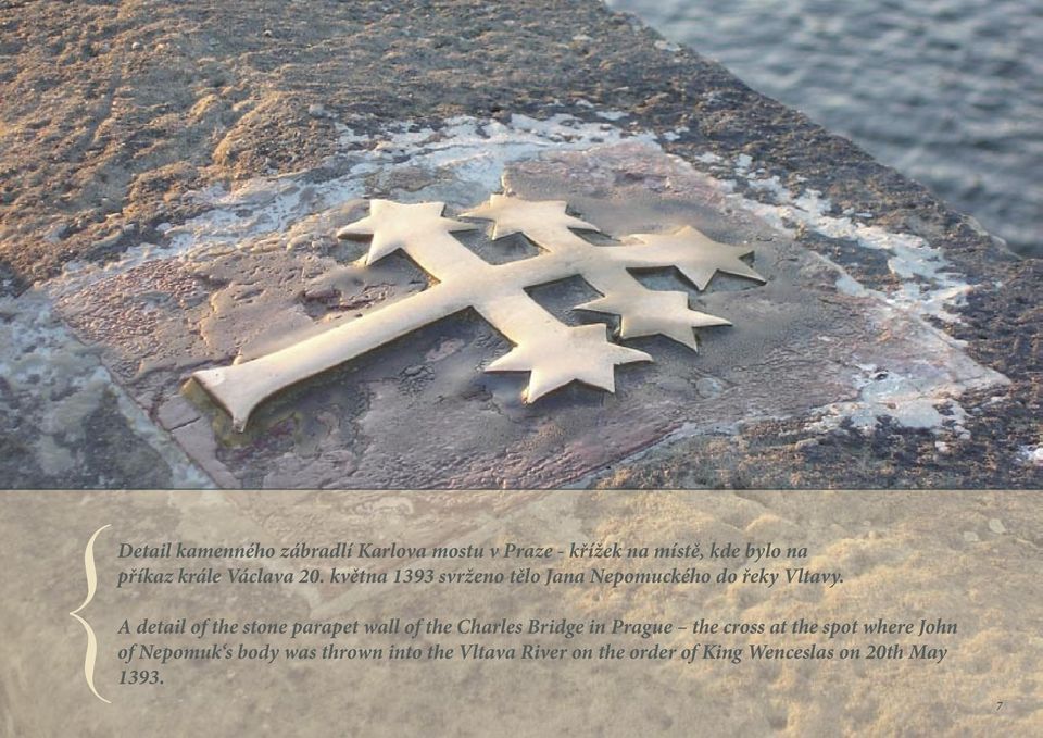 A detail of the stone parapet wall of the Charles Bridge in Prague the cross at the spot