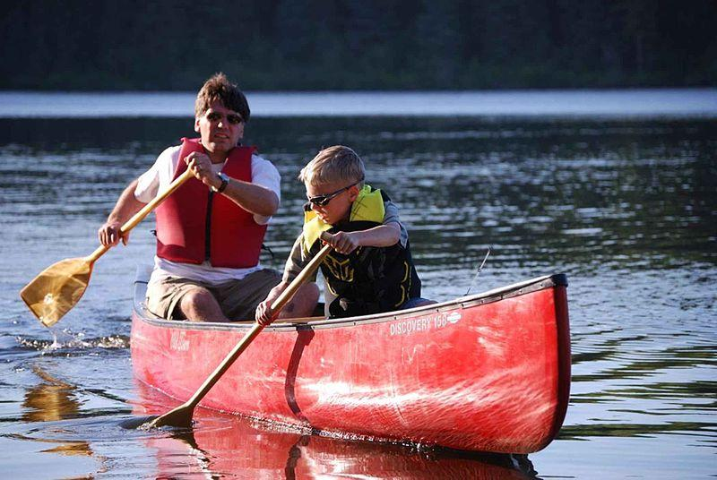 You sit with legs extended forward. - kayak or canoe, paddle, life-vest, neoprene, helmet, sunscreen WWW: http://commons.