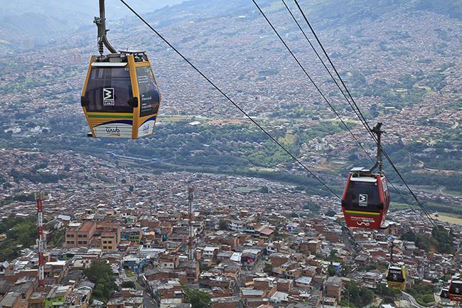 Obr. [1] Lanová dráha ve městě Medellín [2] Ve výrobních závodech se lanových drah využívá například pro přenos součástí při výrobě automobilů.