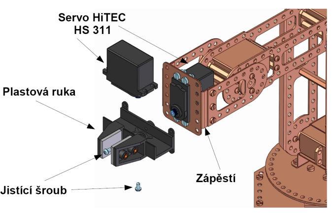 7. Ruka Robota Na zápěstí hybného ramene přiděláme dle vyobrazení servo HiTEC HS 311 pomocí 4 šroubů M3,5 x 10mm do připraveného výřezu.