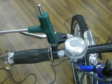 Montáž motoru 1. Otočte bicykl koly nahoru tak aby stál na řidítkách a sedle. Odšroubujte matice držící přední kolo ve vidlici.