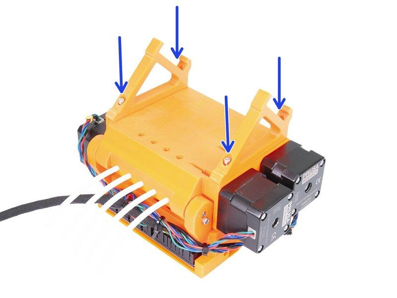 Step 16 Nasazení dílů frame-holder Až bude jednotka MMU2 otočená vzhůru nohama, dejte si POZOR na kabel od F.I.N.D.A. senzoru, který se může zlomit, pokud na něj jednotku nakloníte.
