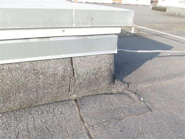 5. Střešní výlez Přístup na střechu je umožněn z prostoru schodišť po žebřících výlezy. Výlezy jsou tvořeny betonovým základem výšky cca 200-250 mm zakrytým plechovým poklopem (foto /19/).