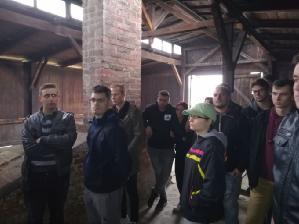 Přede mnou se rozprostírá několik cihlových budov, ve kterých museli žít.