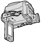 Vložení MiniDV kazety 1 Připojte napájecí zdroj k videokameře, pak posuňte páčku uzávěru kazetové jednotky a otevřete uzávěr.