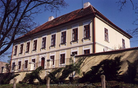 dvě sochy žehnajících biskupů z pískovce. Uprostřed štítu jsou z bývalého okna udělané dveře na půdu kostela. Ve výši základny lomenicového nástavce je na severní straně umístěna pískovcová socha sv.