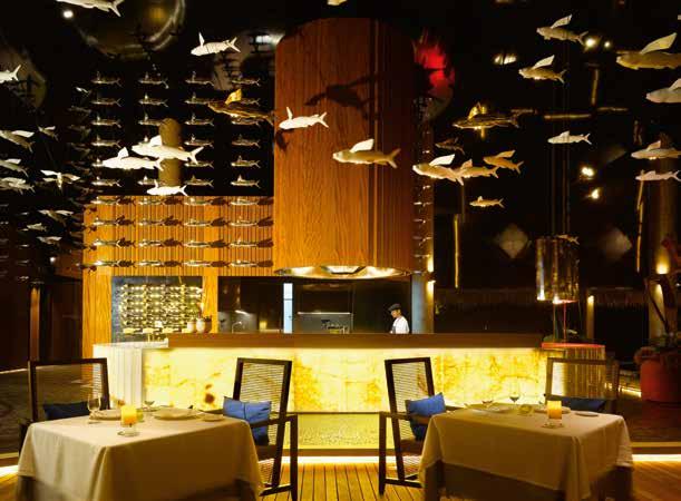 Equipment of the luxury bar backlit from the front made of onyx stone with work-top board made of polymer stone.
