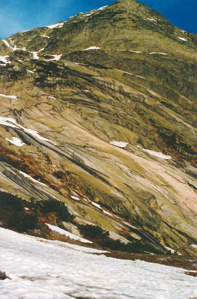 THE ROCKS IN THE VALLEY SLOPE BY CRACKS PARALLEL TO