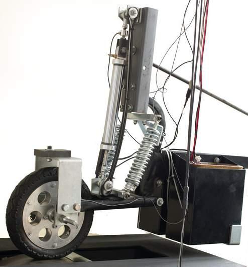 Fig. 1: The experimental trolley (left) and the block scheme of experimental setup The experiment was conducted on a quarter car suspension model (Fig.