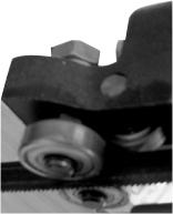 Šroub náklonu se používá ke středění pásů pásovicích. Pilový pás by měl být minimálně ze 2/3 pásovici. Pokud je pásovici menší plochou, šroub náklonu utahujte.