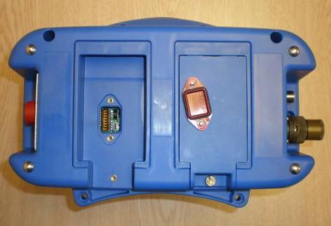 Prostor záložní baterie je umístěn vedle prostoru napájecí baterie a je v něm umístěn červený kryt USB / infra portu a DIP-switch pro nastavení typu baterie.