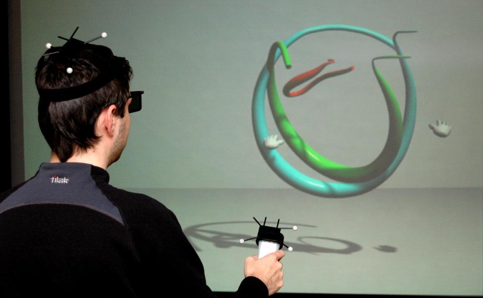 Body Motion Visualization in Virtual Environment 121 (a) (b) Figure 2: Virtual environment: (a) the user wears reflexive marks, control devices and polarized glasses for interaction with VE; (b) the