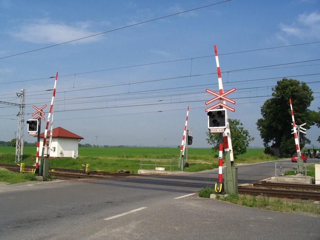 Obr. 5: Světelné přejezdové zabezpečovací zařízení se závorami [9] 2.