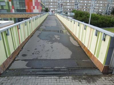 Pohled na lávku od pilíře P1 - stojící voda na konstrukci, poškození vozovky u