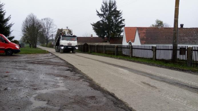 Ve druhém kroku byl povrch zarovnán grejdrem a zhutněn válcem. Následovalo přidání pojiva (cement). Toto pojivo bylo nadávkováno na povrch urovnané vrstvy (obrázek č. 23).