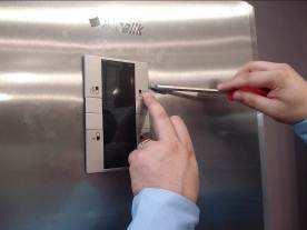 There are slots on the side of the display frame to insert the tip of the flat screwdriver.