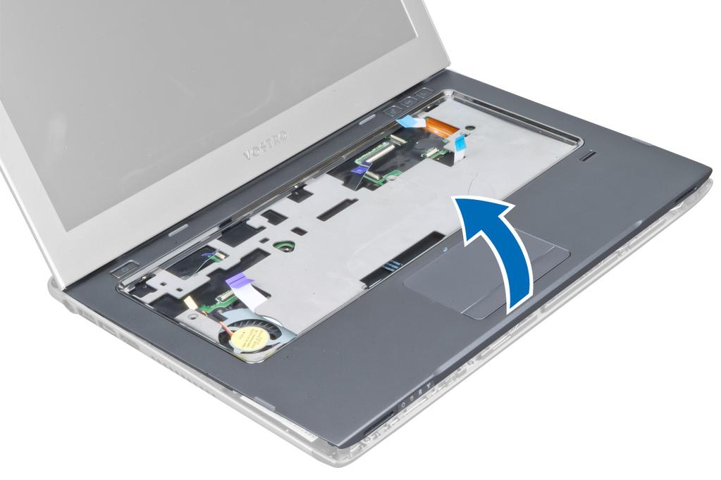 9. Zvedněte opěrku pro dlaně nahoru a vyjměte ji z počítače. Instalace opěrky pro dlaně 1. Od okrajů opěrky pro dlaně tlačte směrem dolů na opěrku, aby úchyty na počítači zapadly na své místo. 2.